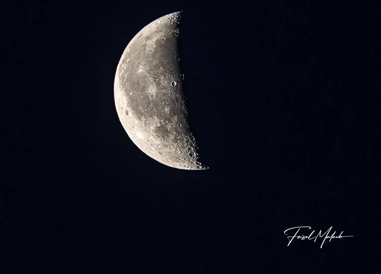 Crescent moon over deep blue night photographed by Faisal Malaeb.