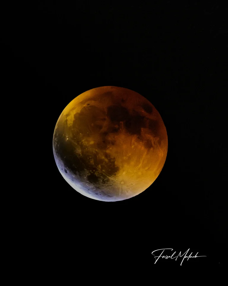 Warm eclipse shadow on the moon photographed by Faisal Malaeb.